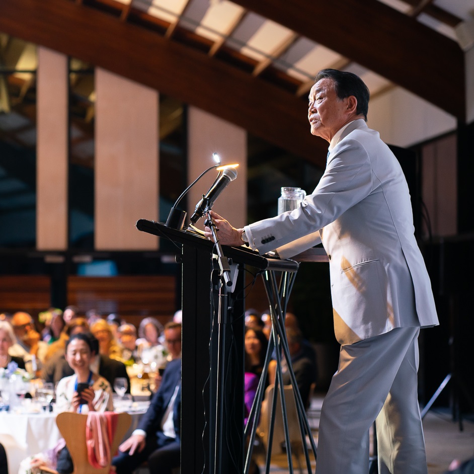 Taro Aso giving a speech in an auditorium